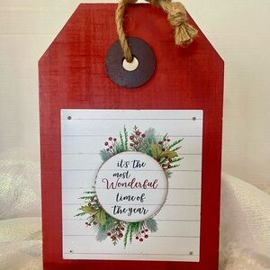 This is a rustic red wooden Christmas holiday sign with a rope hanger!